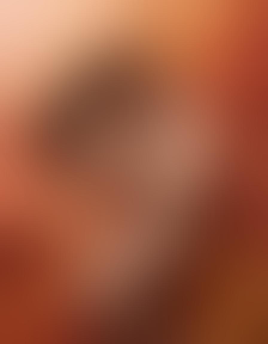 A sensual and tasteful depiction of intertwined bodies in soft, fluid motions, surrounded by a gradient of warm colors representing the spectrum of desire. Subtle hints of nature, such as flowers and soft fabrics, create an intimate atmosphere. The composition blends eroticism with elegance, evoking a sense of mature exploration. An inviting ambiance with soft lighting enhances the captivating allure of the scene. super-realistic. warm tones. soft focus.